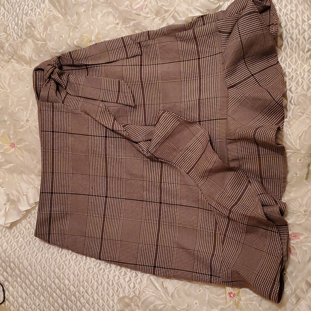 Cute Brown plaid skirt with ruffle and belt tie detailing.